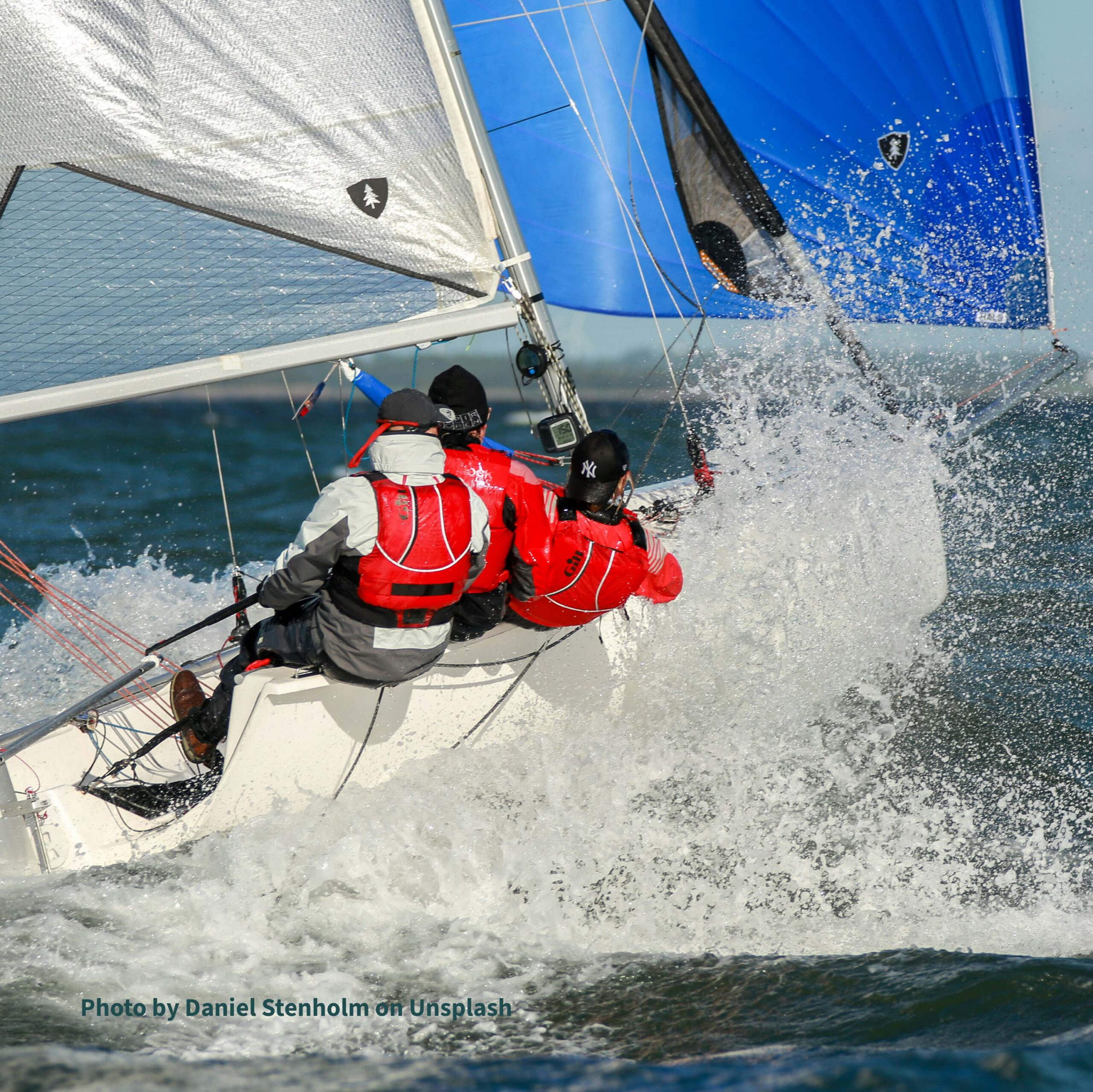 Sailboat crue actively managing the boat during a race