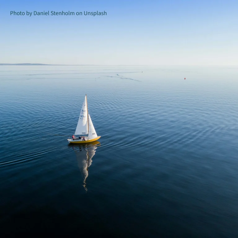 Sailboat cruising smoothly on calm waters
