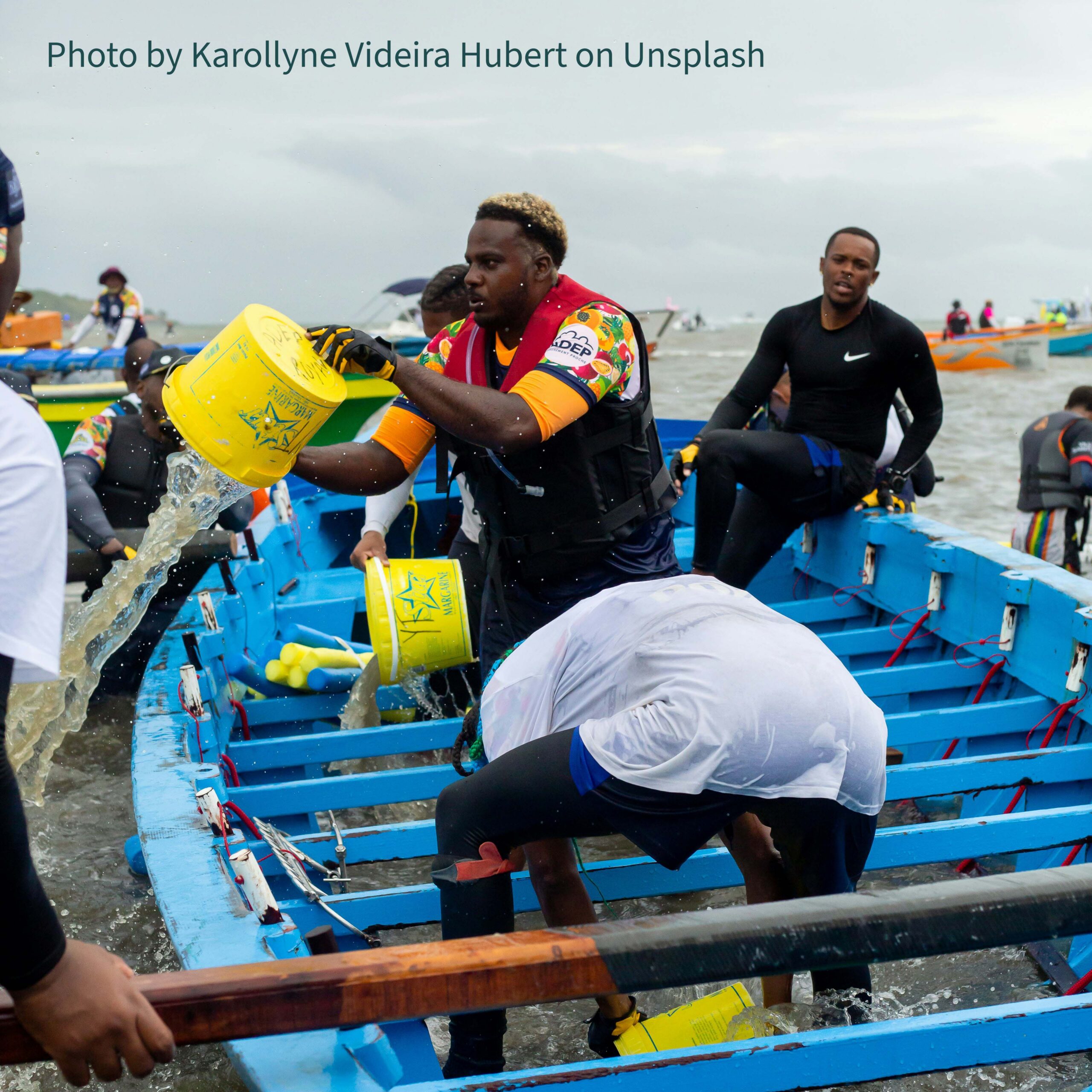Crew bailing water from boat
